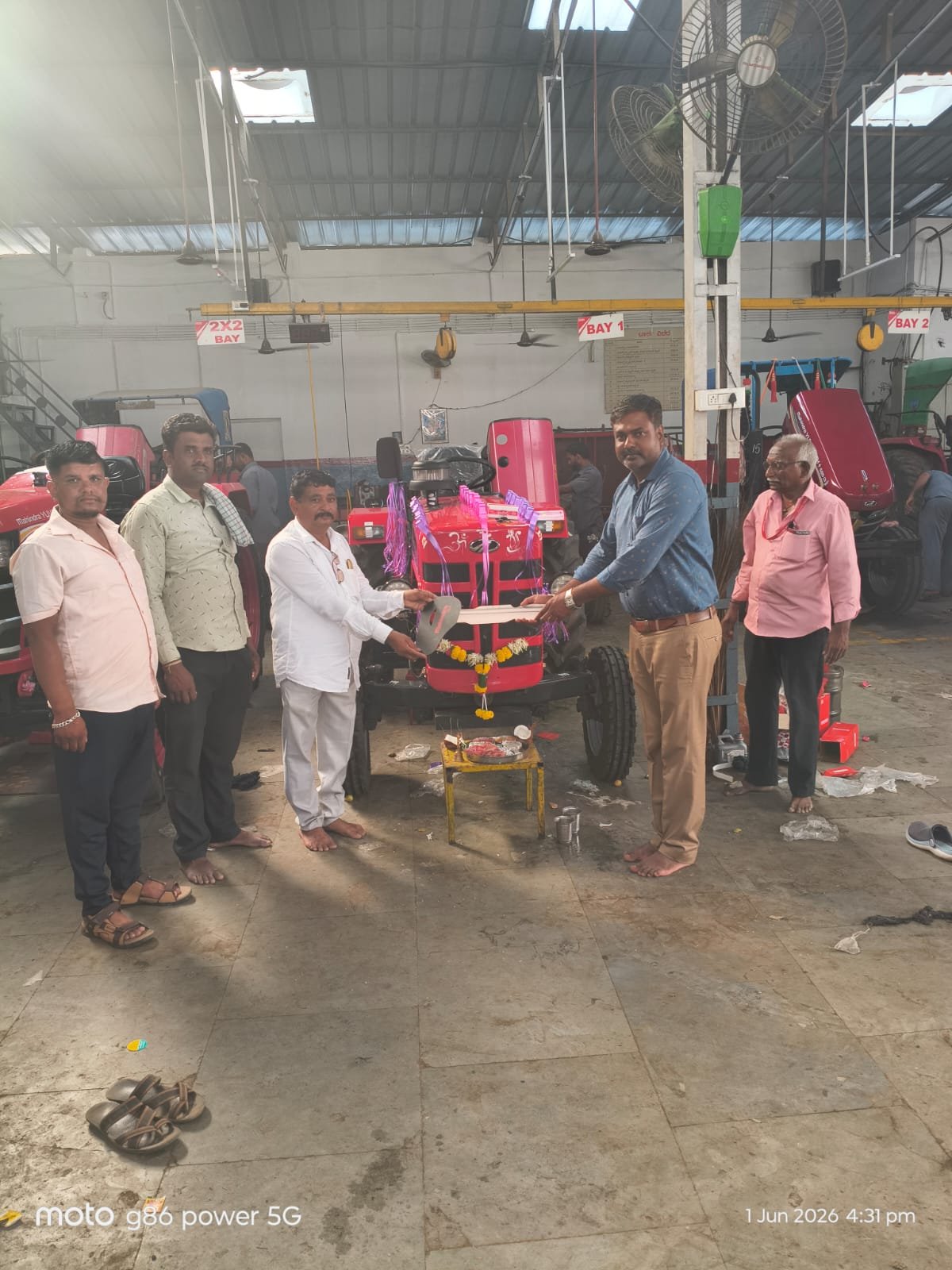 Farmer receiving tractor keys at dealership delivery ceremony